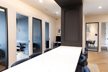 A conference room with a long table and chairs at The Crest at South Point Apartments, Davenport 